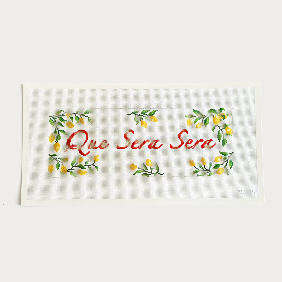 Hand-painted "Que Sera Sera" needlepoint canvas with lemon border, 5.5” x 15” on 13 mesh.