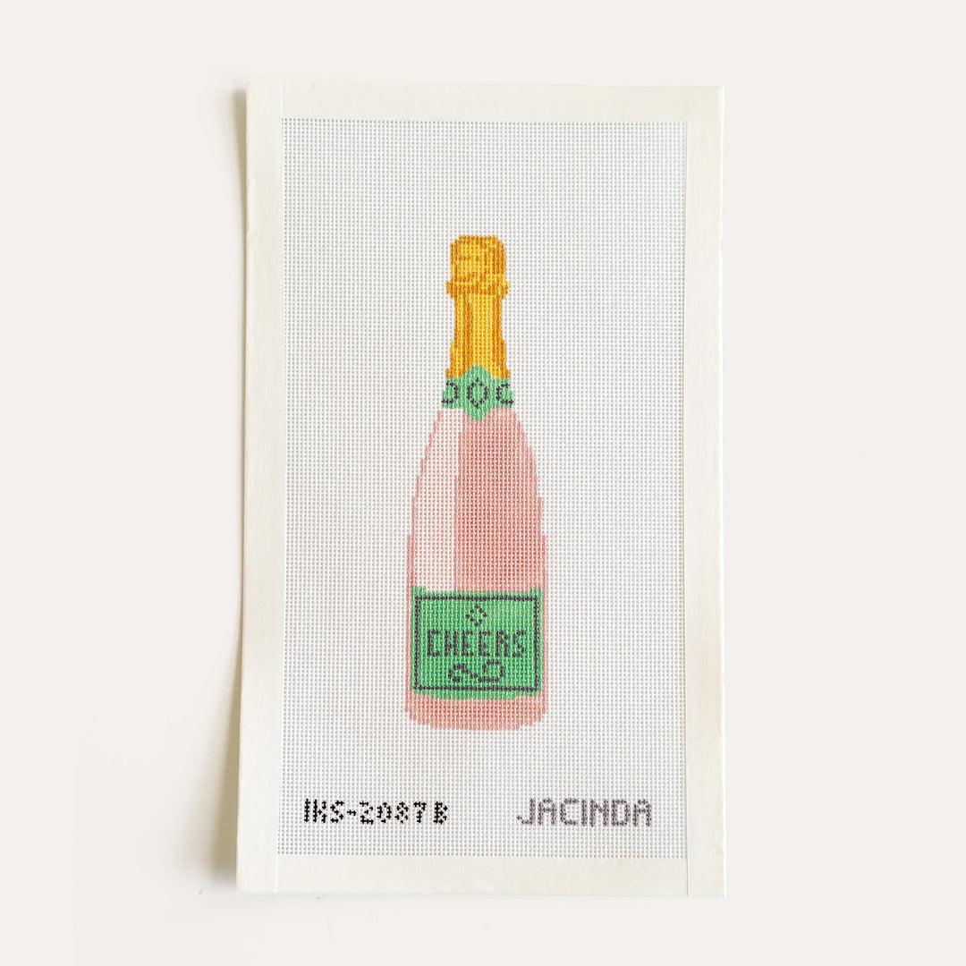 Hand-painted Cheers champagne bottle needlepoint ornament on 18 mesh canvas by Jacinda Boneau