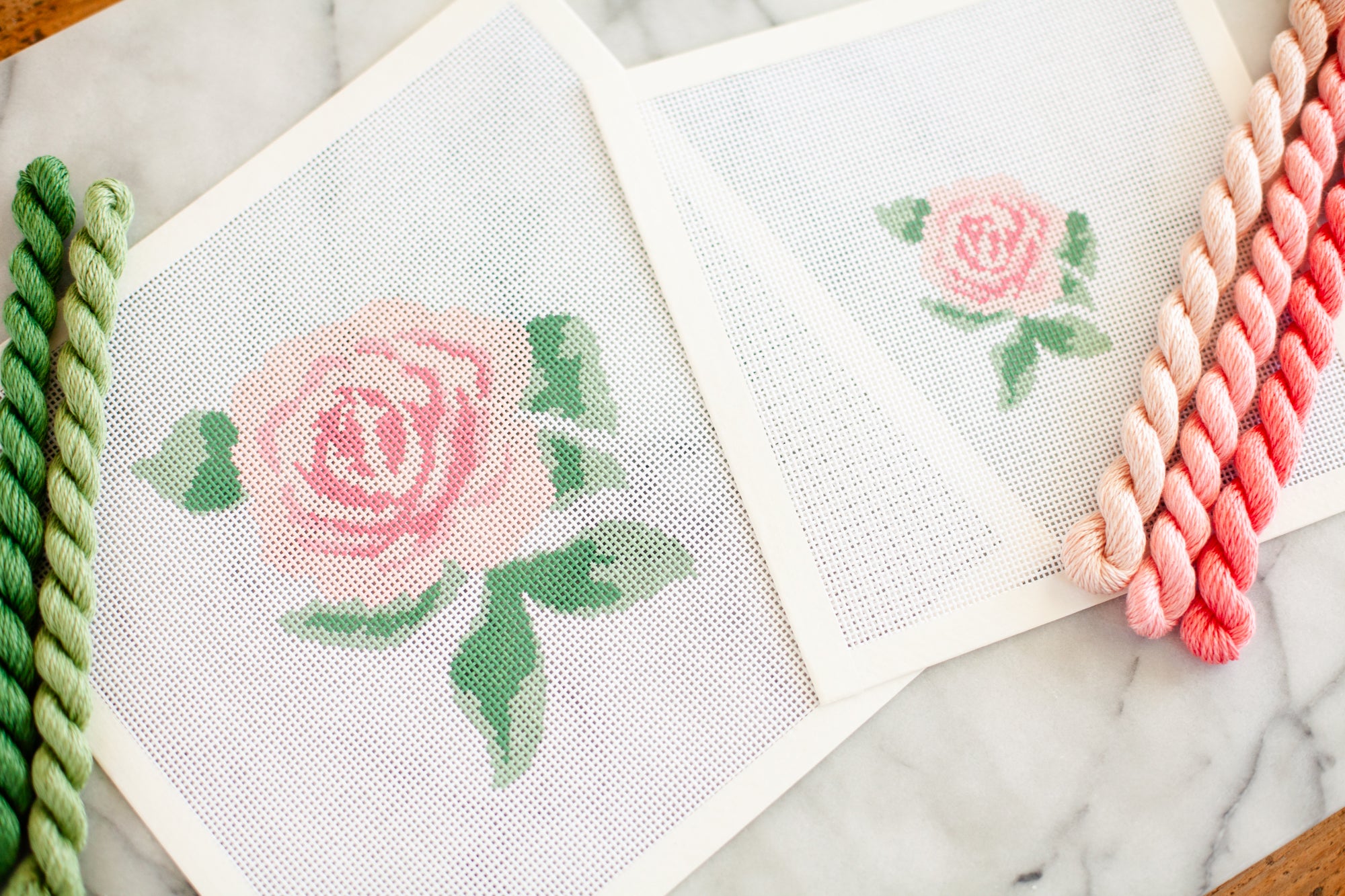 one large and one small pink rose design on needlepoint canvas