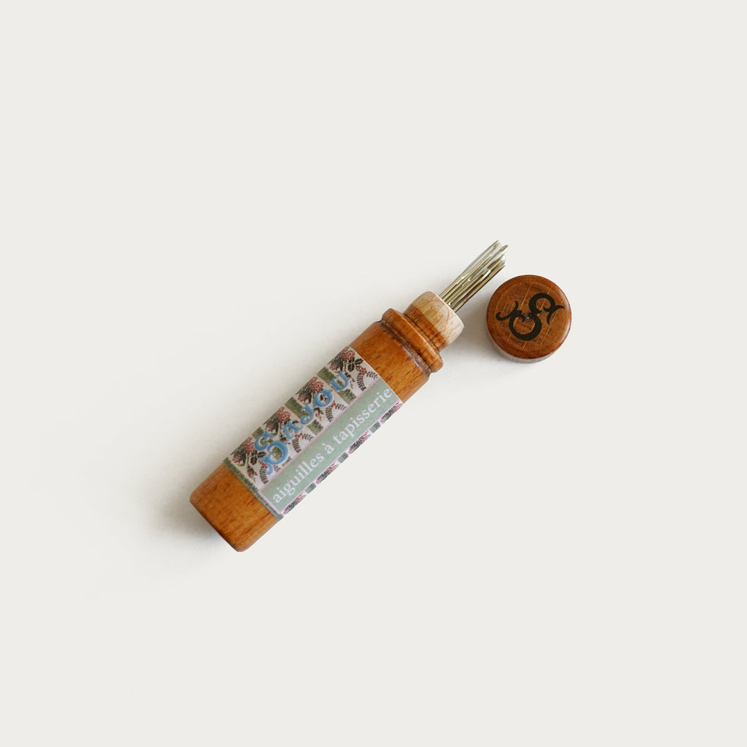 Sajou wooden needle case with floral label, includes six No. 26 tapestry needles, ideal for needlepoint and embroidery.
