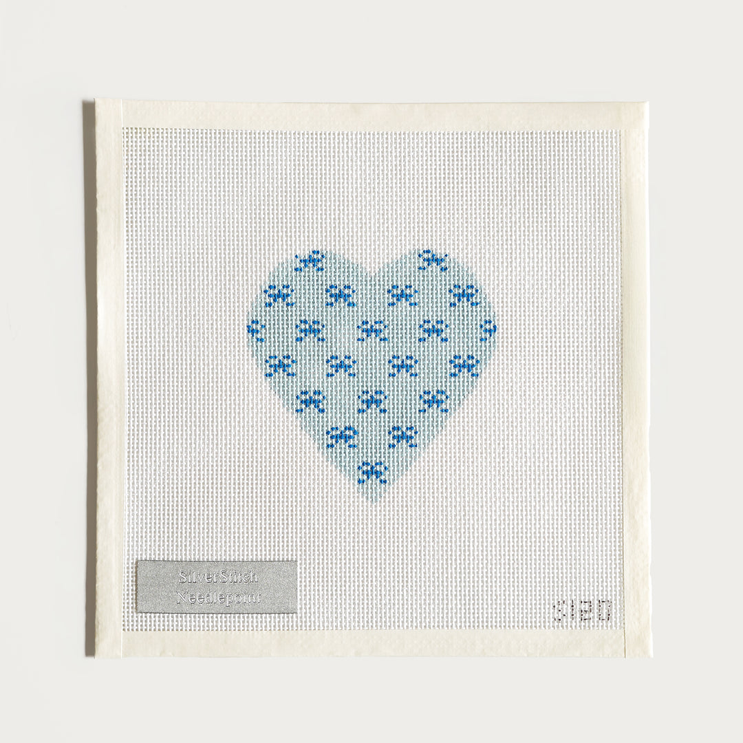 Hand-painted Valentine Mini Bows needlepoint canvas (on 13 mesh), featuring a heart filled with blue bows.