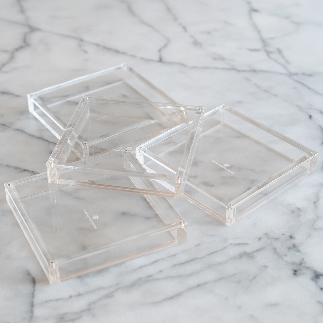 set of four clear acrylic magnetic coasters for displaying 4x4 needlepoint in a modern minimal style