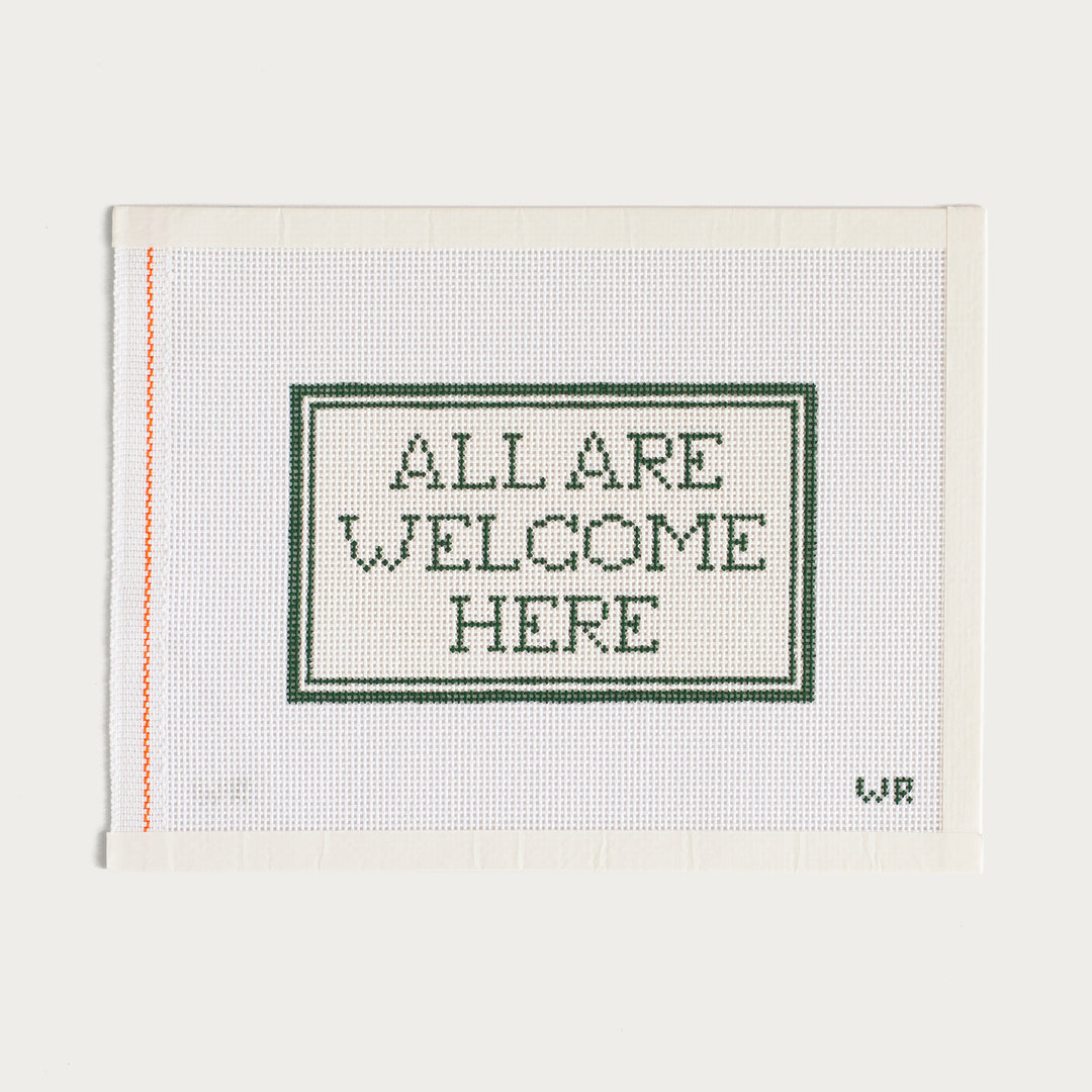 Hand-painted All Are Welcome Here needlepoint canvas with an inclusive message.