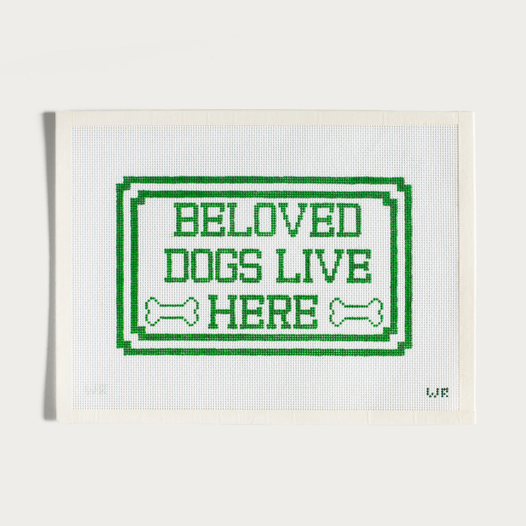 Hand-painted Beloved Dogs Live Here needlepoint canvas with a pet-themed design.