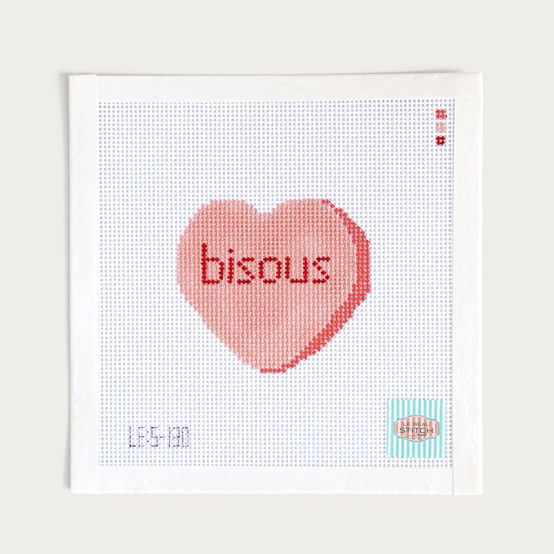 Hand-painted ‘Bisous’ Candy Conversation Heart needlepoint canvas on 13 mesh, featuring a sweet French-inspired design.