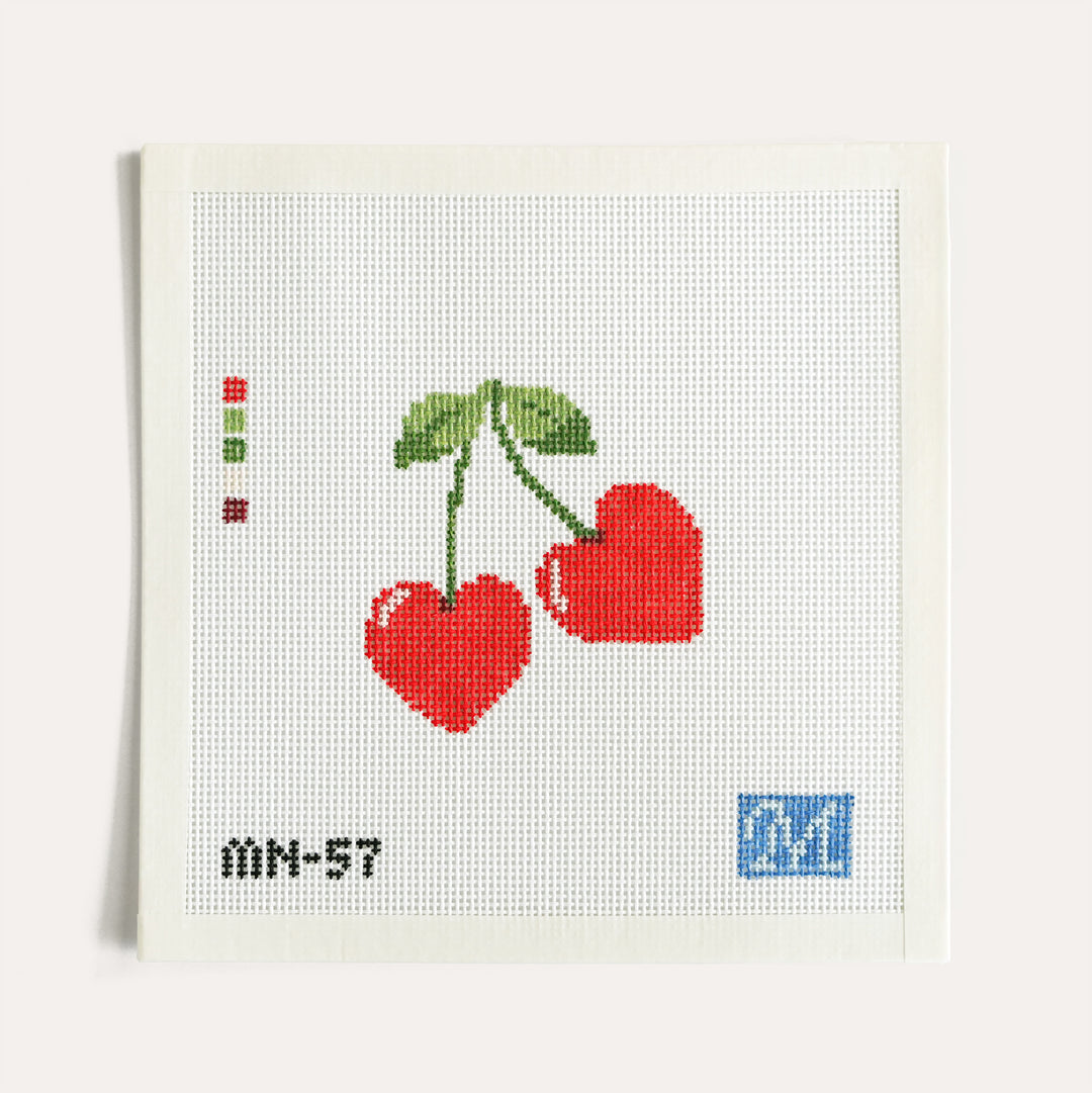 Cherry Love Bomb needlepoint canvas on 13 mesh with two heart-shaped cherries by Maura Nolan