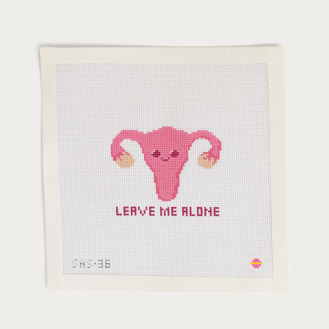 Cuterus needlepoint canvas by Saturnalia Stitching on 18 mesh with pink uterus and Leave Me Alone text
