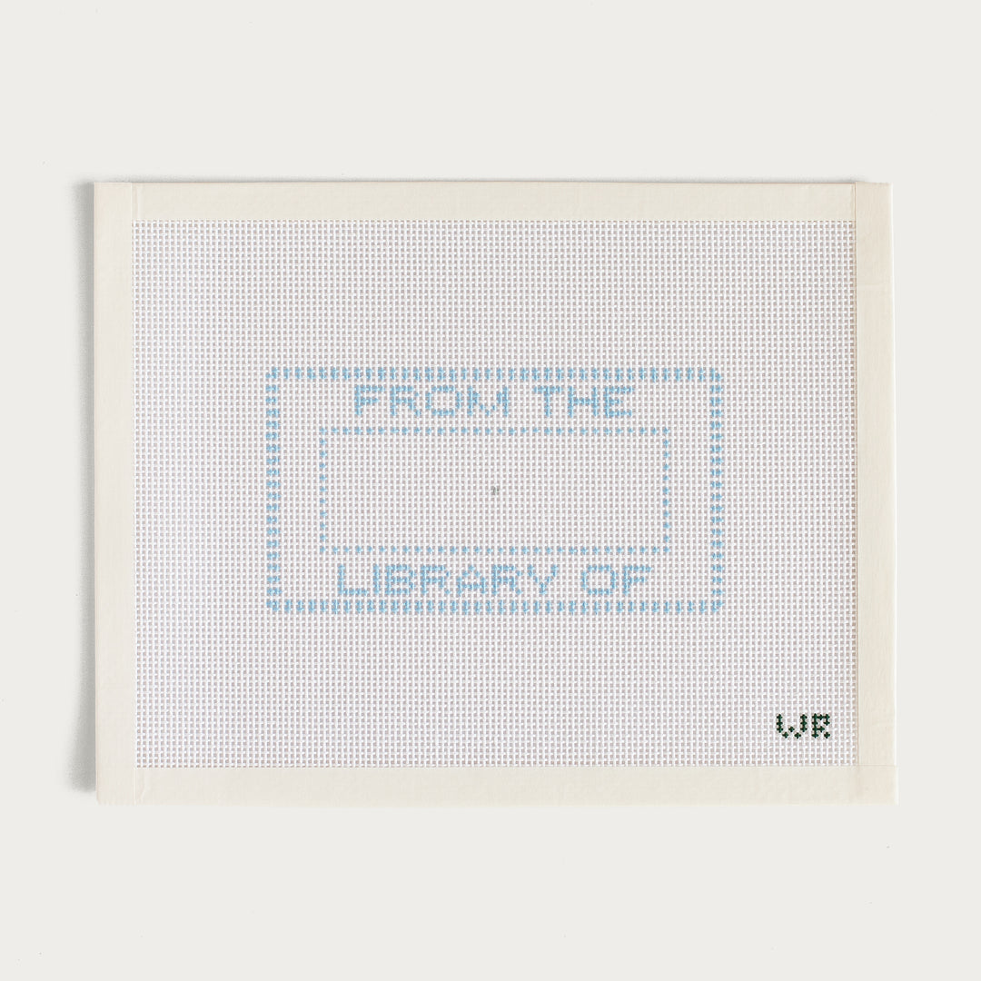 Hand-painted From the Library Of needlepoint canvas with a classic bookplate design.