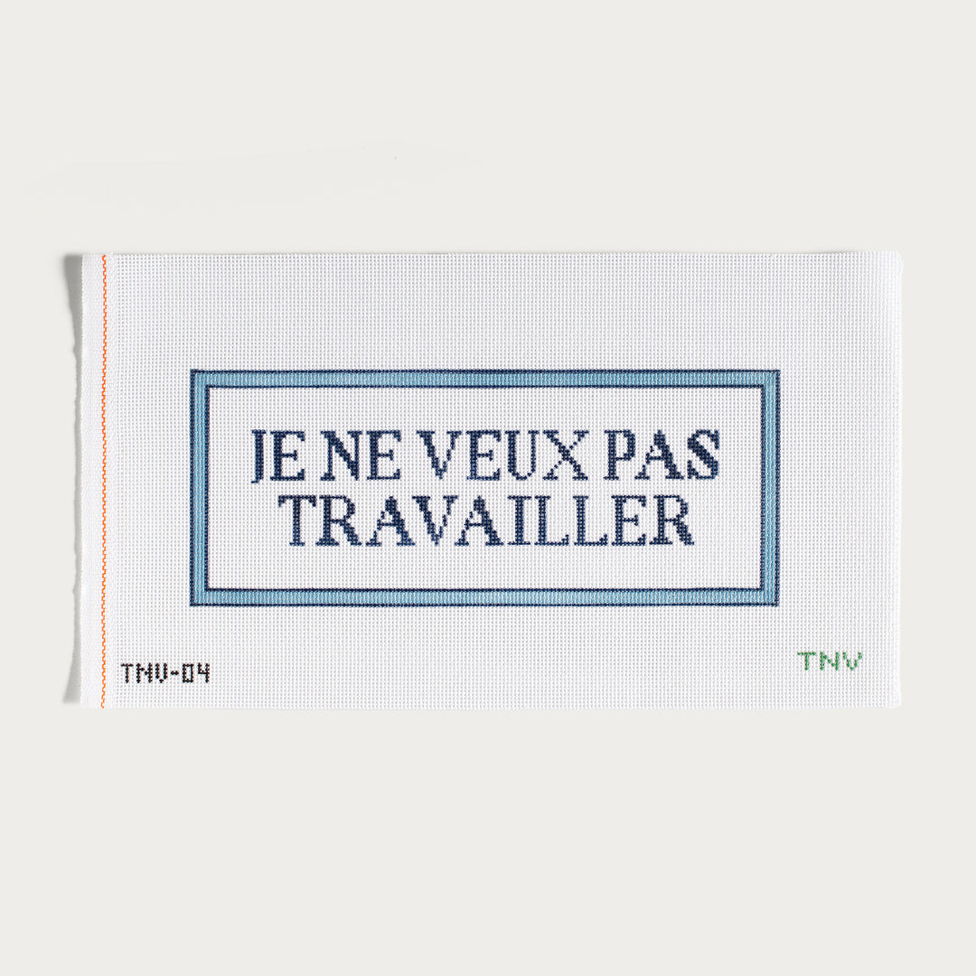 Hand-painted Je Ne Veux Pas Travailler needlepoint canvas with a playful French statement.