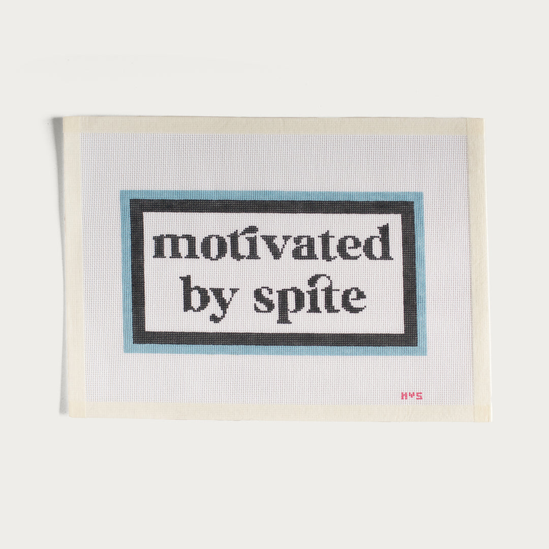 Hand-painted Motivated By Spite needlepoint canvas in blue with a bold statement design.