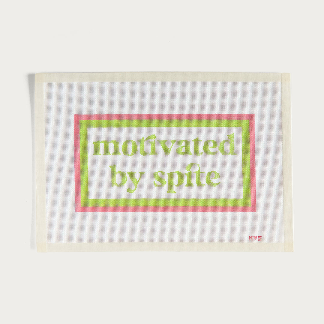 Hand-painted Motivated By Spite needlepoint canvas in pink and green with a bold statement design.