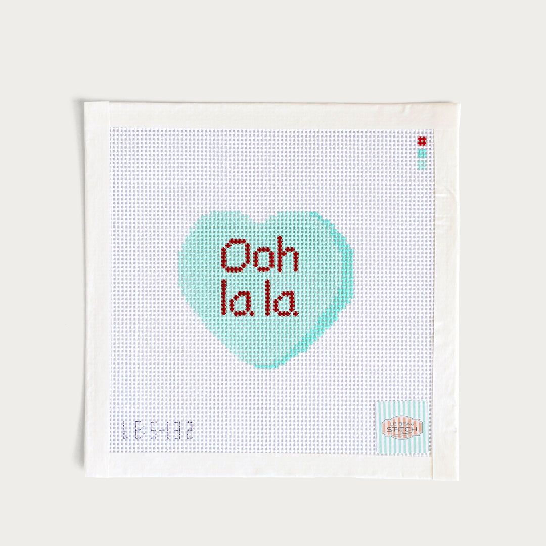 Hand-painted ‘Ooh La La’ Candy Conversation Heart needlepoint canvas on 13 mesh with a French-inspired Valentine’s design.